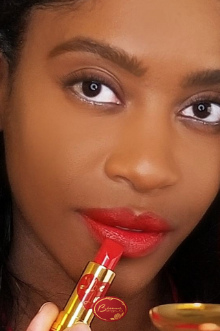 Black Woman Applying Bésame's Red lipstick