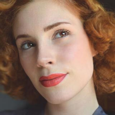 Red Haired Woman Wearing Bésame Cosmetics Red Lipstick