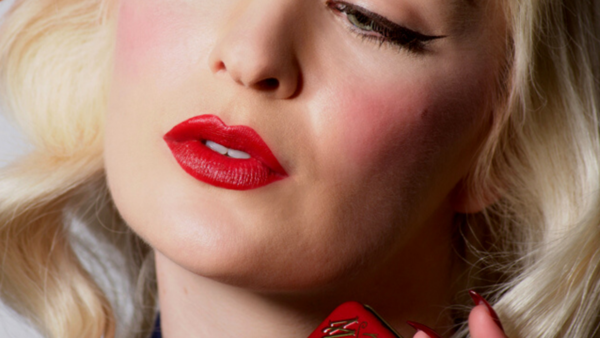 Woman Wearing Bésame's Red Lipstick and Cake Mascara